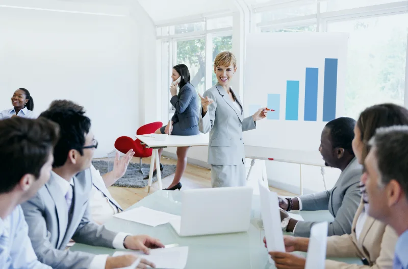 Presenter explaining a growth chart to a team