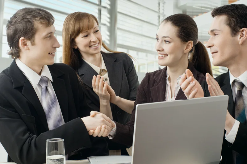 Colleagues shaking hands in an office