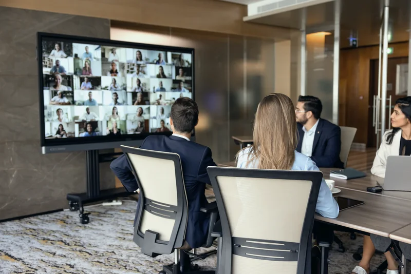 Team meeting a remote group over video call